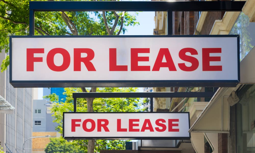 two for lease signs next to each other